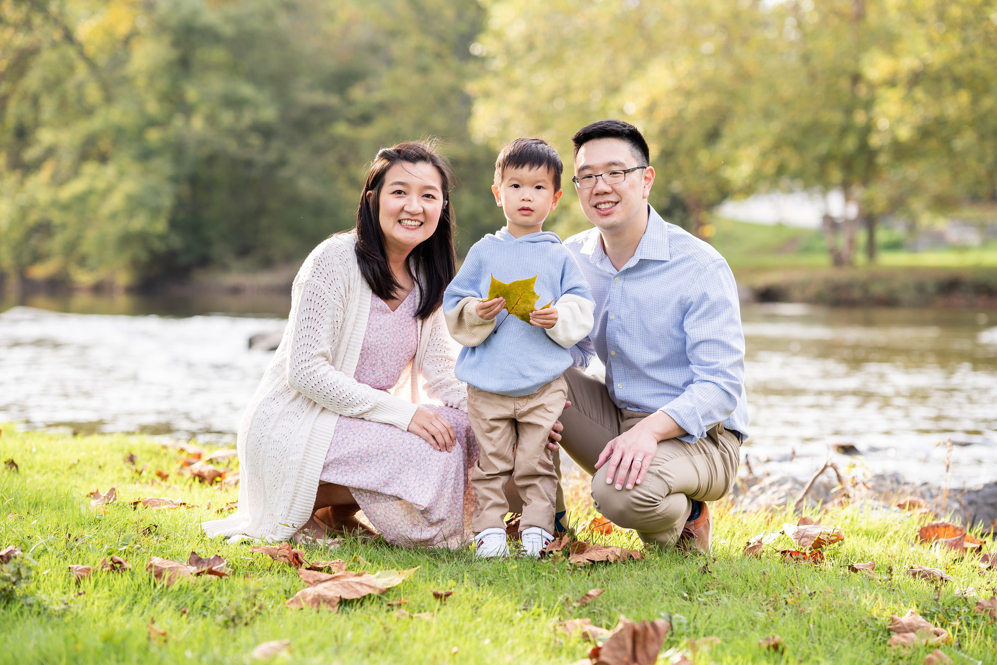 Wide shot of family in autumn leaves